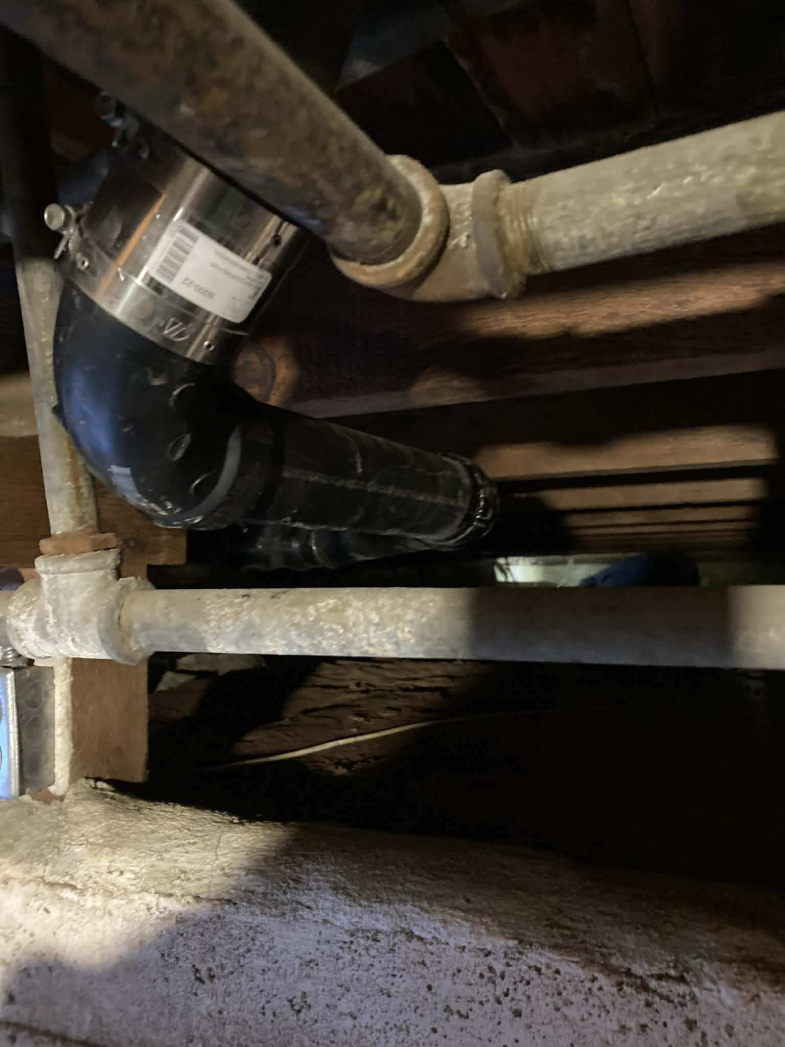 Crawl space sump pump installation under floor joists
