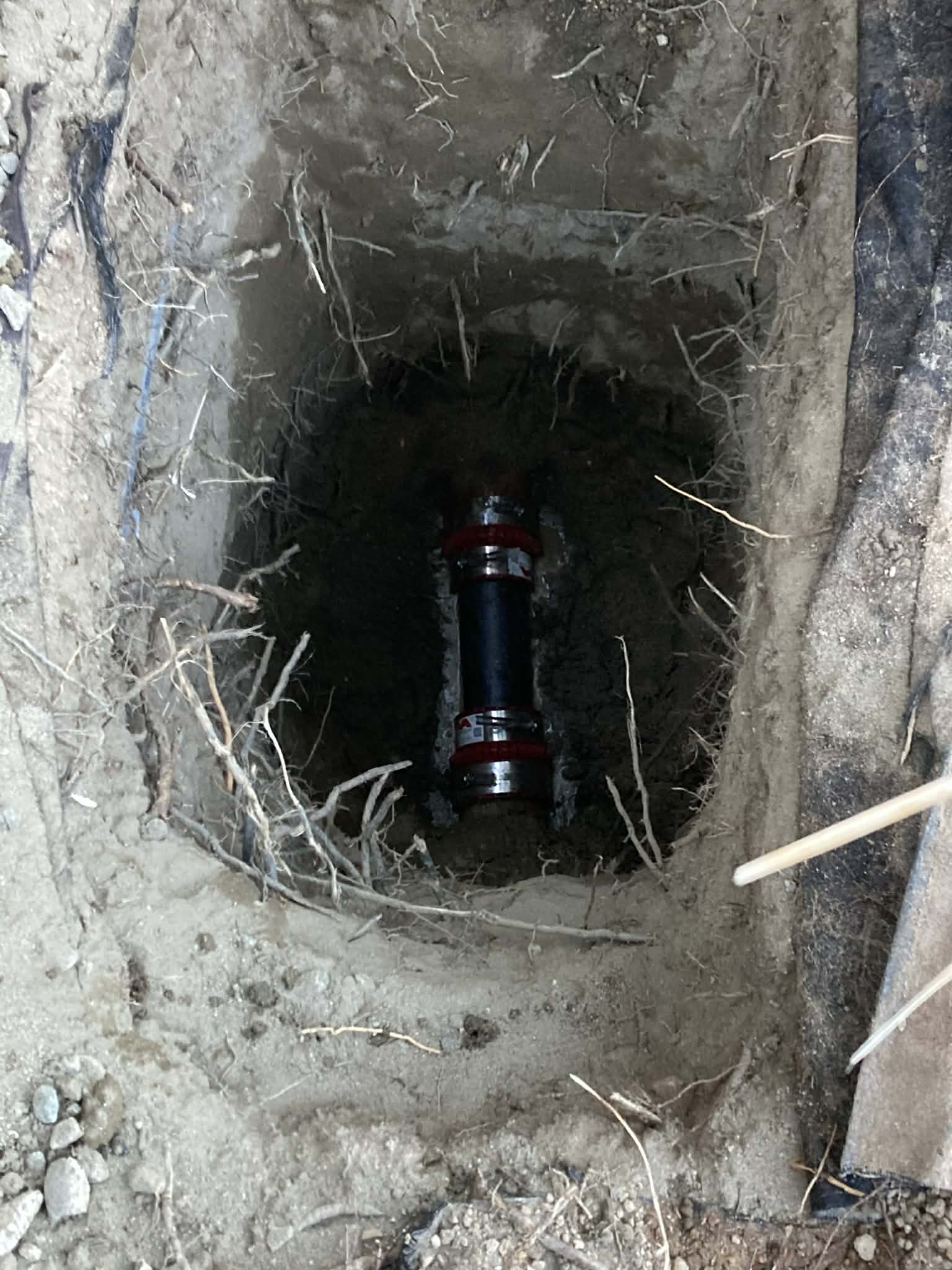 Underground sewer line repair with new coupling installed